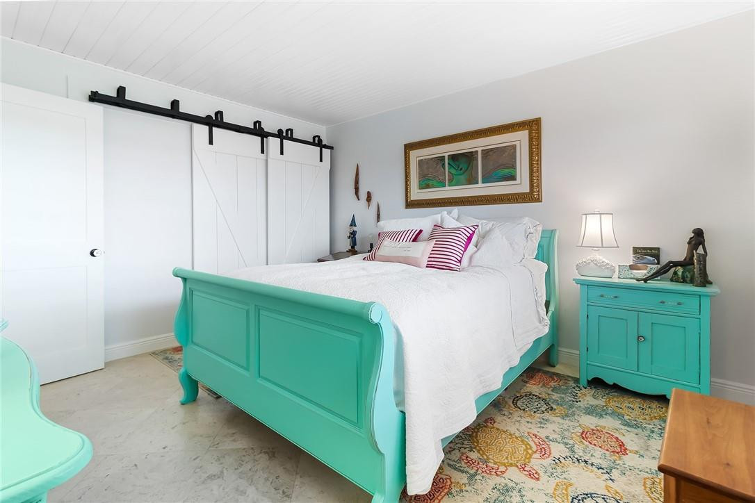 2871 North Ocean Boulevard, Unit D518 Boca Raton, FL 33431 - Photo 13 of 28 a bedroom with a bed and a mirror