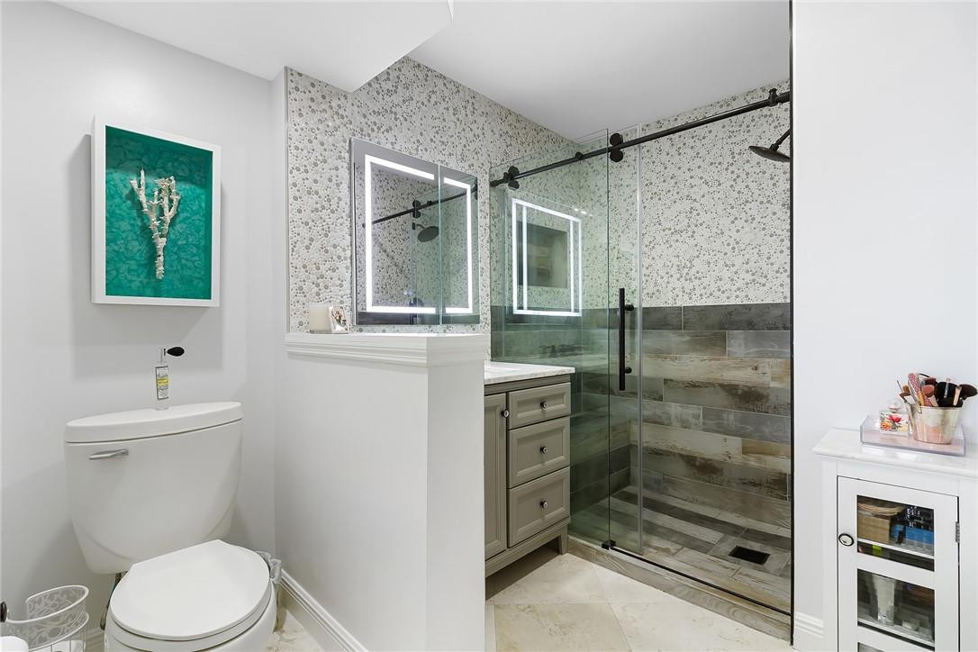 2871 North Ocean Boulevard, Unit D518 Boca Raton, FL 33431 - Photo 15 of 28 a bathroom with a toilet sink and shower