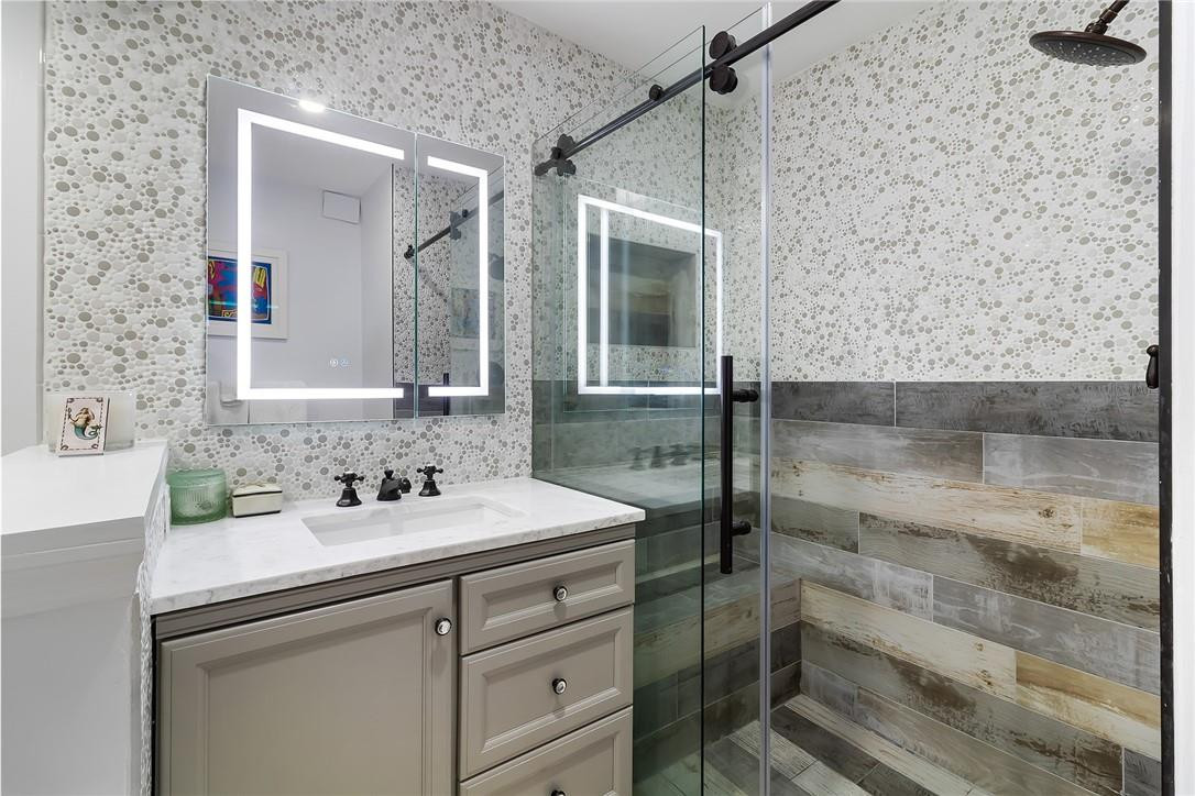 2871 North Ocean Boulevard, Unit D518 Boca Raton, FL 33431 - Photo 16 of 28 a bathroom with a sink and a mirror