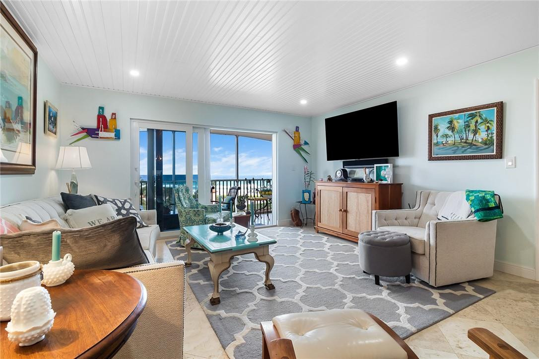 2871 North Ocean Boulevard, Unit D518 Boca Raton, FL 33431 - Photo 5 of 28 a living room with furniture and a flat screen tv