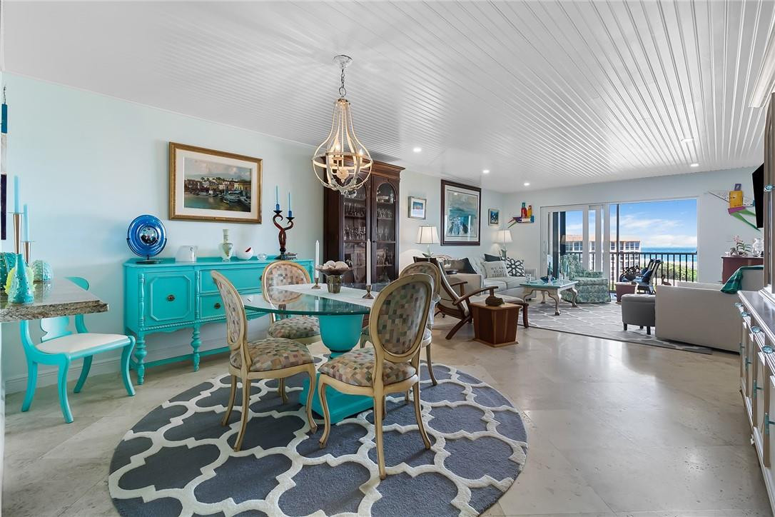 2871 North Ocean Boulevard, Unit D518 Boca Raton, FL 33431 - Photo 8 of 28 a living room with furniture a rug and a chandelier