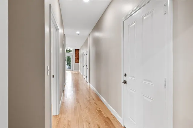 a view of hallway with wooden floor