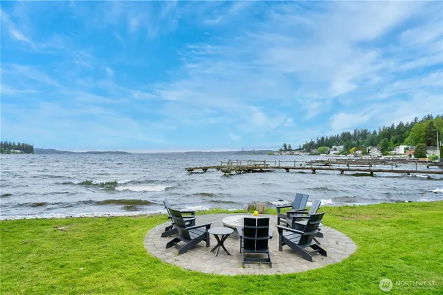 a view of a swimming pool and outdoor seating