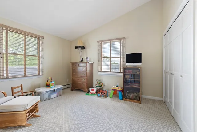 a view of game room with toys and windows