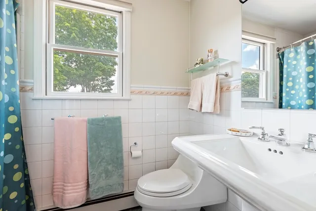 a white toilet sitting next to a bathroom sink