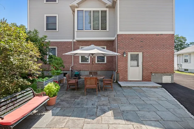 a view of a house with backyard and sitting area