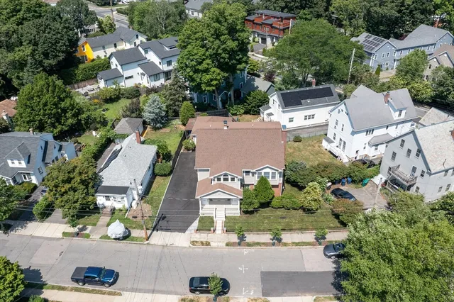 an aerial view of residential houses with outdoor space and street view
