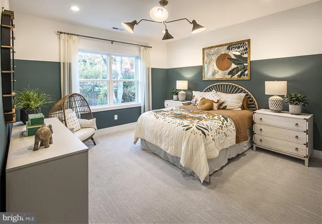 a bedroom with bed and a large window