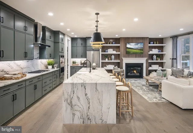 a large kitchen with stainless steel appliances kitchen island granite countertop a sink and cabinets