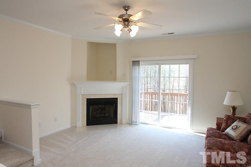 8419 Reedy Ridge Lane Raleigh, NC 27613 - Photo 2 of 20 wooden floor fireplace and windows in an empty room