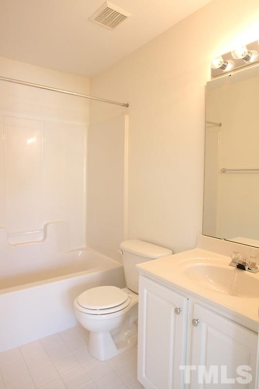 8419 Reedy Ridge Lane Raleigh, NC 27613 - Photo 13 of 20 a bathroom with a toilet a sink and bathtub