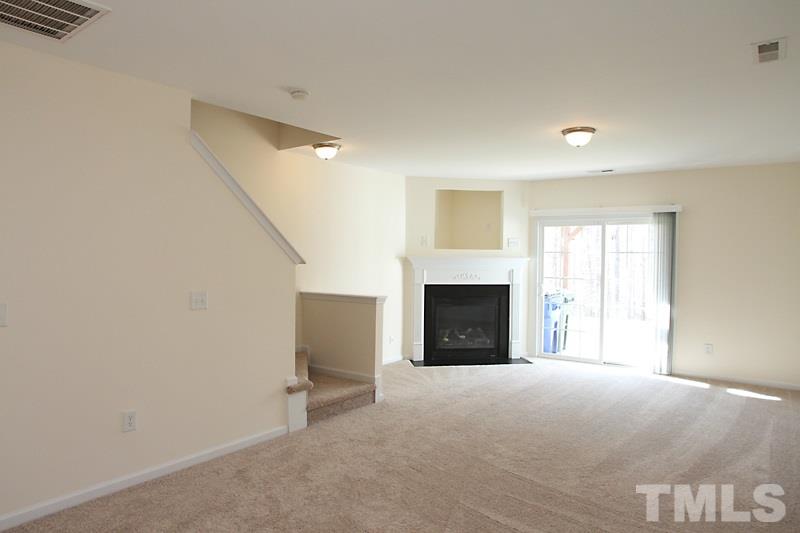 8419 Reedy Ridge Lane Raleigh, NC 27613 - Photo 14 of 20 a view of an empty room with a fireplace and a window