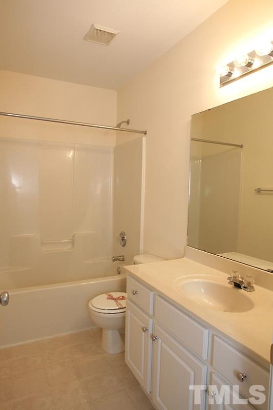 8419 Reedy Ridge Lane Raleigh, NC 27613 - Photo 15 of 20 a bathroom with a sink a toilet and shower