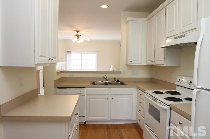 8419 Reedy Ridge Lane Raleigh, NC 27613 - Photo 6 of 20 a kitchen with stainless steel appliances a white stove top oven cabinets and a window