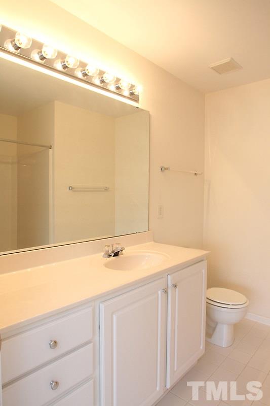 8419 Reedy Ridge Lane Raleigh, NC 27613 - Photo 10 of 20 a bathroom with a sink a toilet and vanity