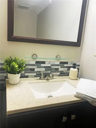 a bathroom with a sink a mirror and vanity
