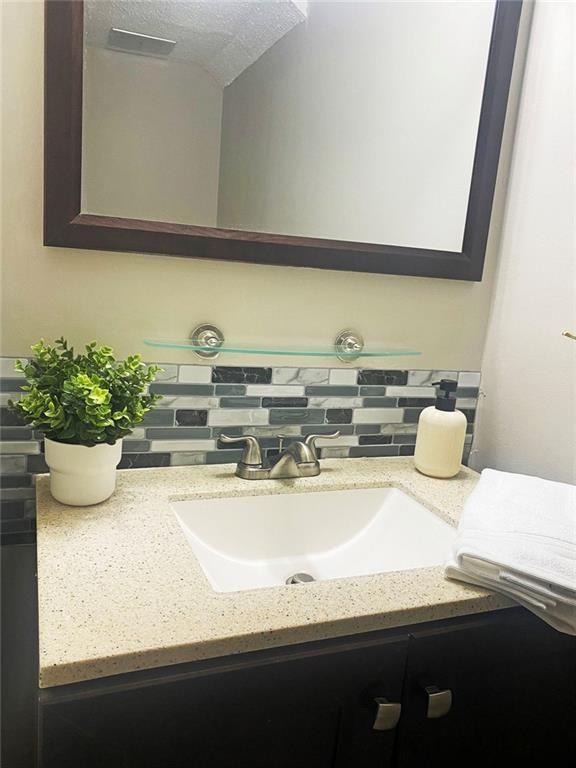 4701 Flat Shoals Road, Unit 5D Union City, GA 30291 - Photo 12 of 20 a bathroom with a sink a mirror and vanity
