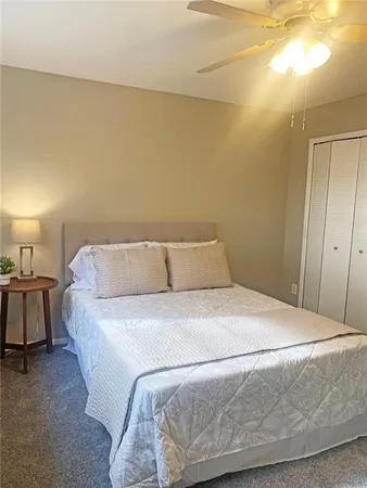 a bedroom with a bed and lamp