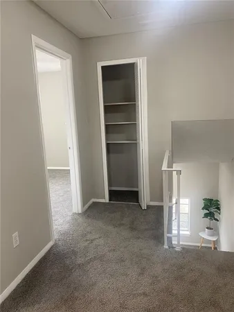 an empty room with closet and entryway