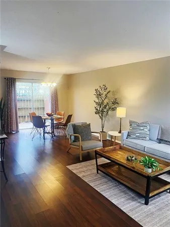 a living room with furniture and wooden floor