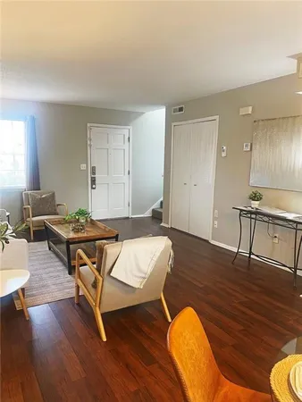 a living room with dining room and wooden floor