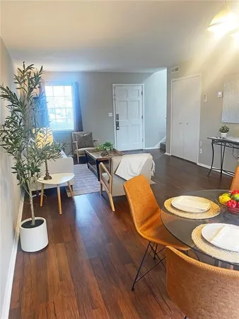a living room with furniture and wooden floor