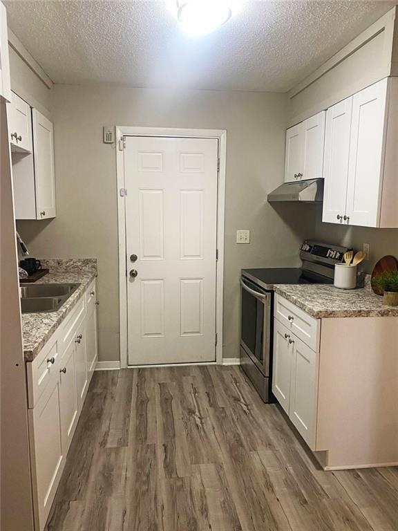 4701 Flat Shoals Road, Unit 5D Union City, GA 30291 - Photo 8 of 20 a kitchen with a sink stove and cabinets