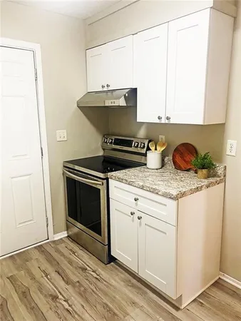 a kitchen with granite countertop a stove and a sink