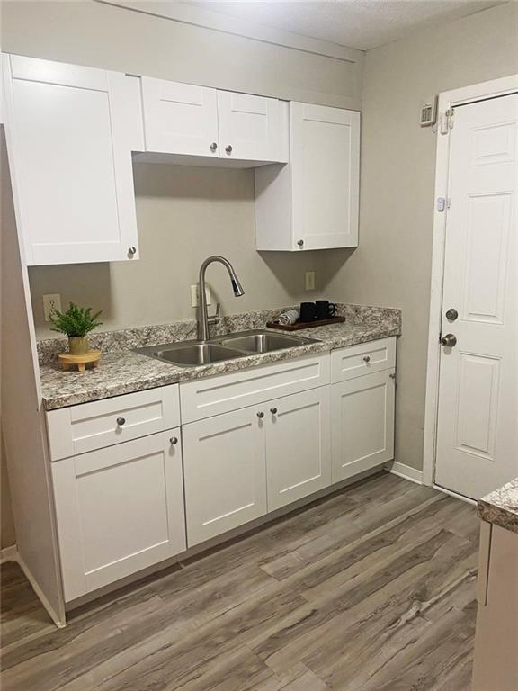4701 Flat Shoals Road, Unit 5D Union City, GA 30291 - Photo 10 of 20 a kitchen with stainless steel appliances granite countertop a sink a stove and white cabinets