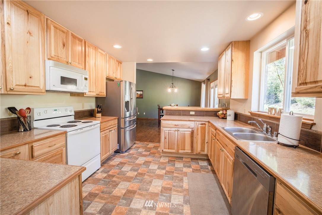 204 Webb Road Southwest Lakebay, WA 98349 - Photo 14 of 31 a kitchen with a sink stove top oven and cabinets