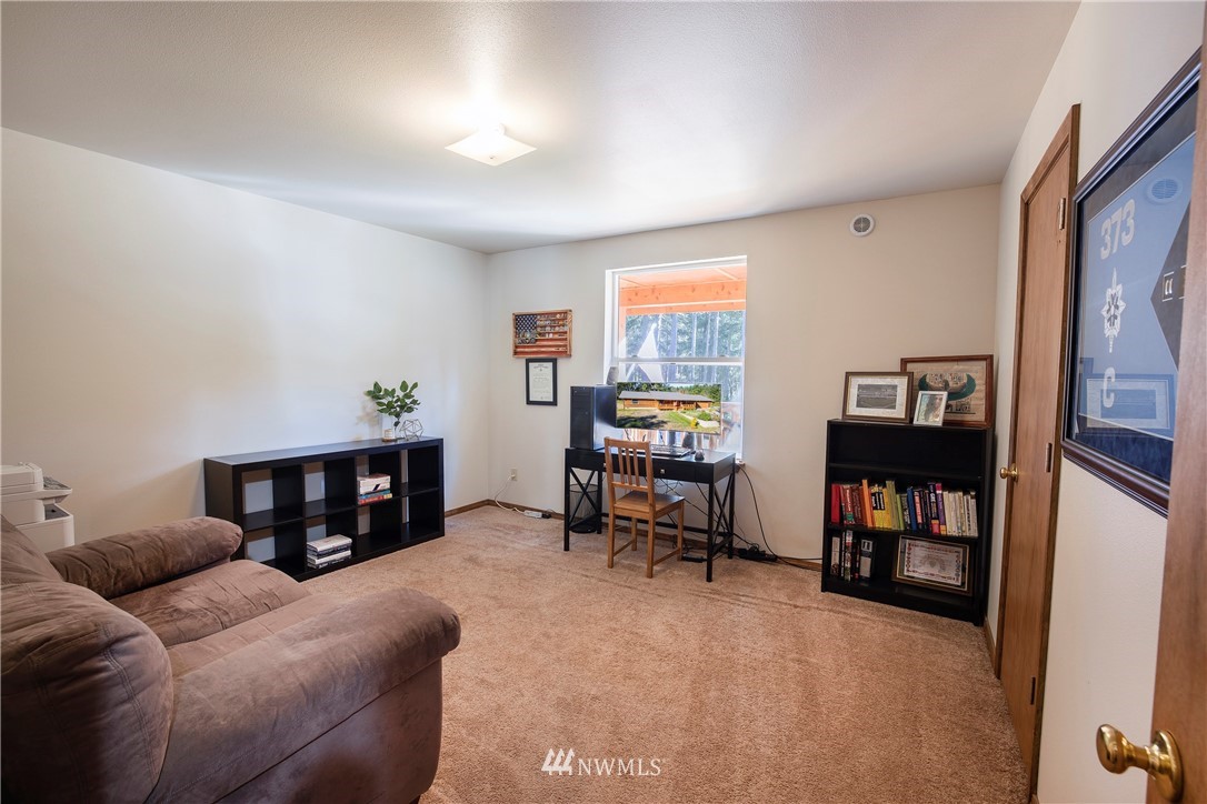 204 Webb Road Southwest Lakebay, WA 98349 - Photo 22 of 31 a living room with furniture and a bookshelf