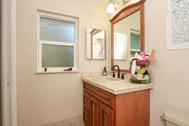 a bathroom with a sink vanity and a mirror