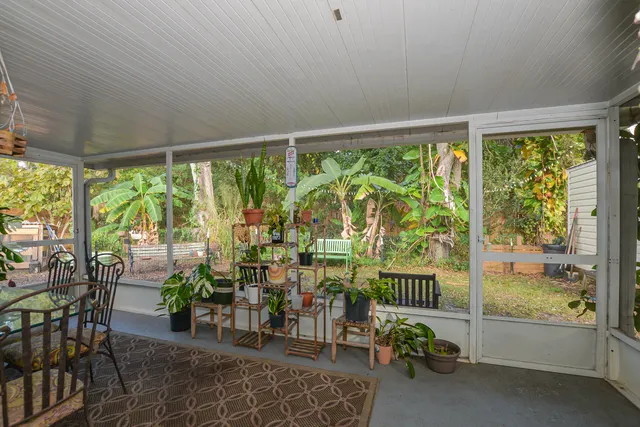 a view of a porch with chairs and backyard