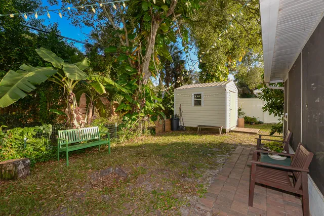 a backyard of a house with a tree