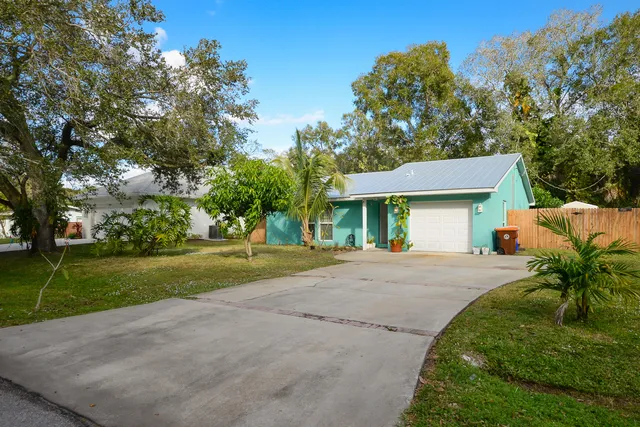 a front view of a house with a yard and a garage