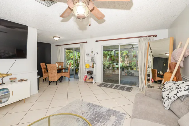 a view of a livingroom with furniture and a flat screen tv