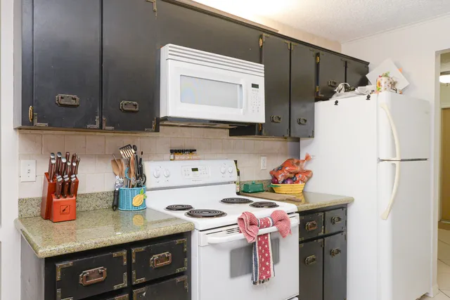a kitchen with a refrigerator and a sink
