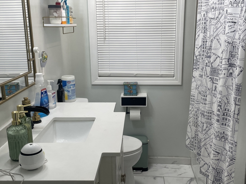 26 Sylvan Street Worcester, MA 01603 - Photo 11 of 28 a bathroom with a sink and a toilet