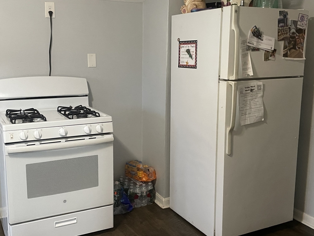26 Sylvan Street Worcester, MA 01603 - Photo 14 of 28 a white refrigerator freezer and a stove sitting inside of a kitchen