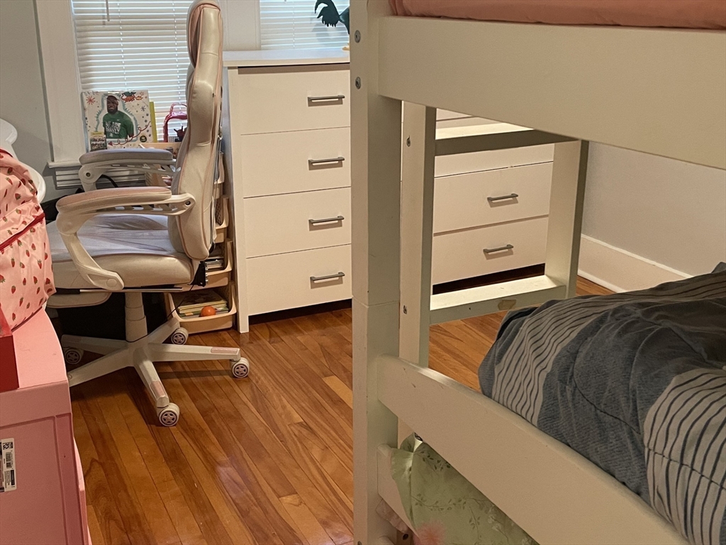 26 Sylvan Street Worcester, MA 01603 - Photo 17 of 28 a bedroom with a bed and wooden floor