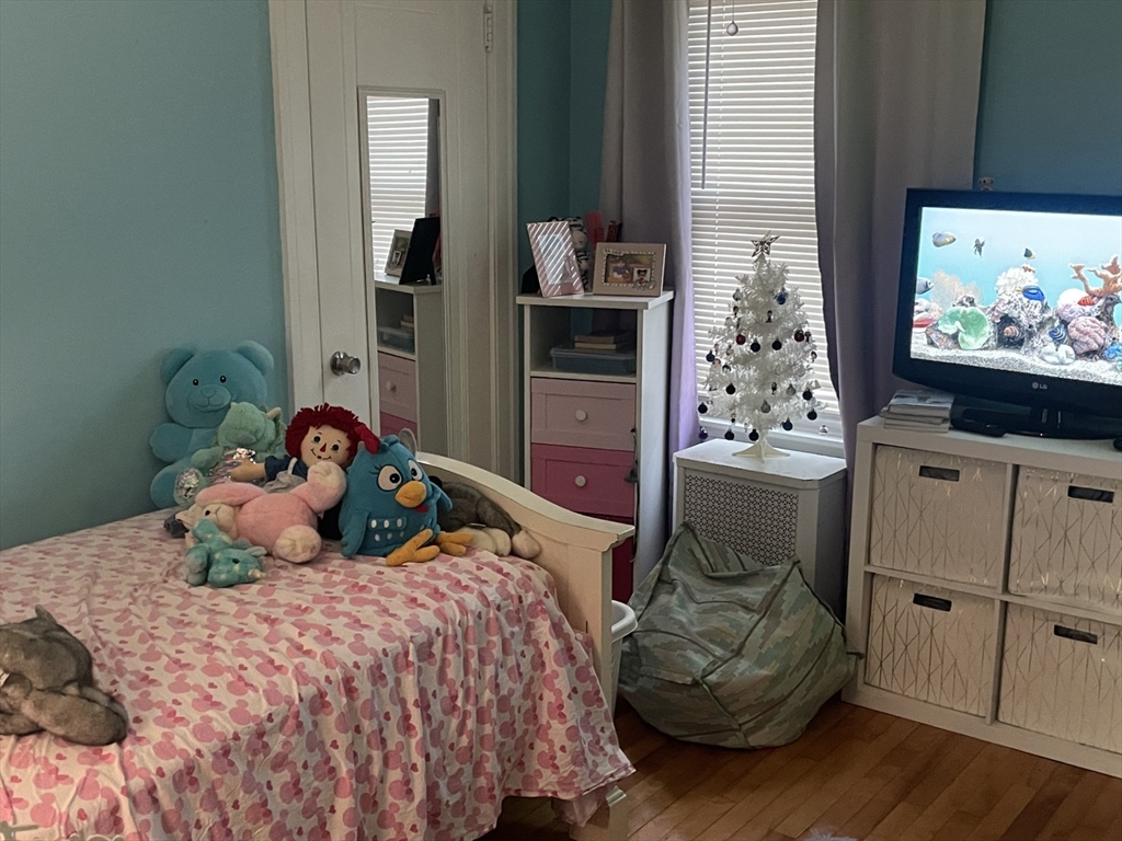 26 Sylvan Street Worcester, MA 01603 - Photo 7 of 28 a bedroom with a bed and wooden floor