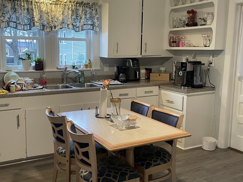 26 Sylvan Street Worcester, MA 01603 - Photo 9 of 28 a kitchen with a sink a stove and chairs
