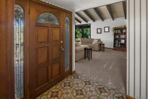 a living room with furniture and floor to ceiling windows