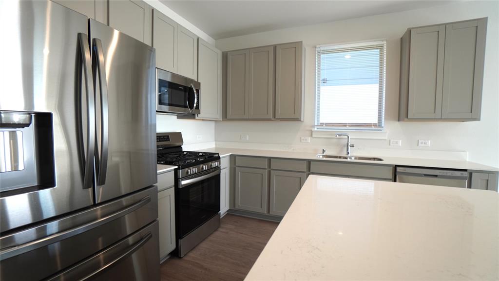 1374 Chisos Way Forney, TX 75126 - Photo 9 of 25 a kitchen with stainless steel appliances granite countertop a refrigerator stove and sink