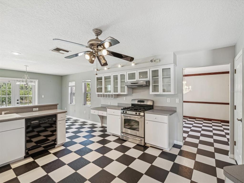15420 Aubrey Avenue Spring Hill, FL 34610 - Photo 8 of 28 a kitchen with stainless steel appliances a stove a sink and a refrigerator