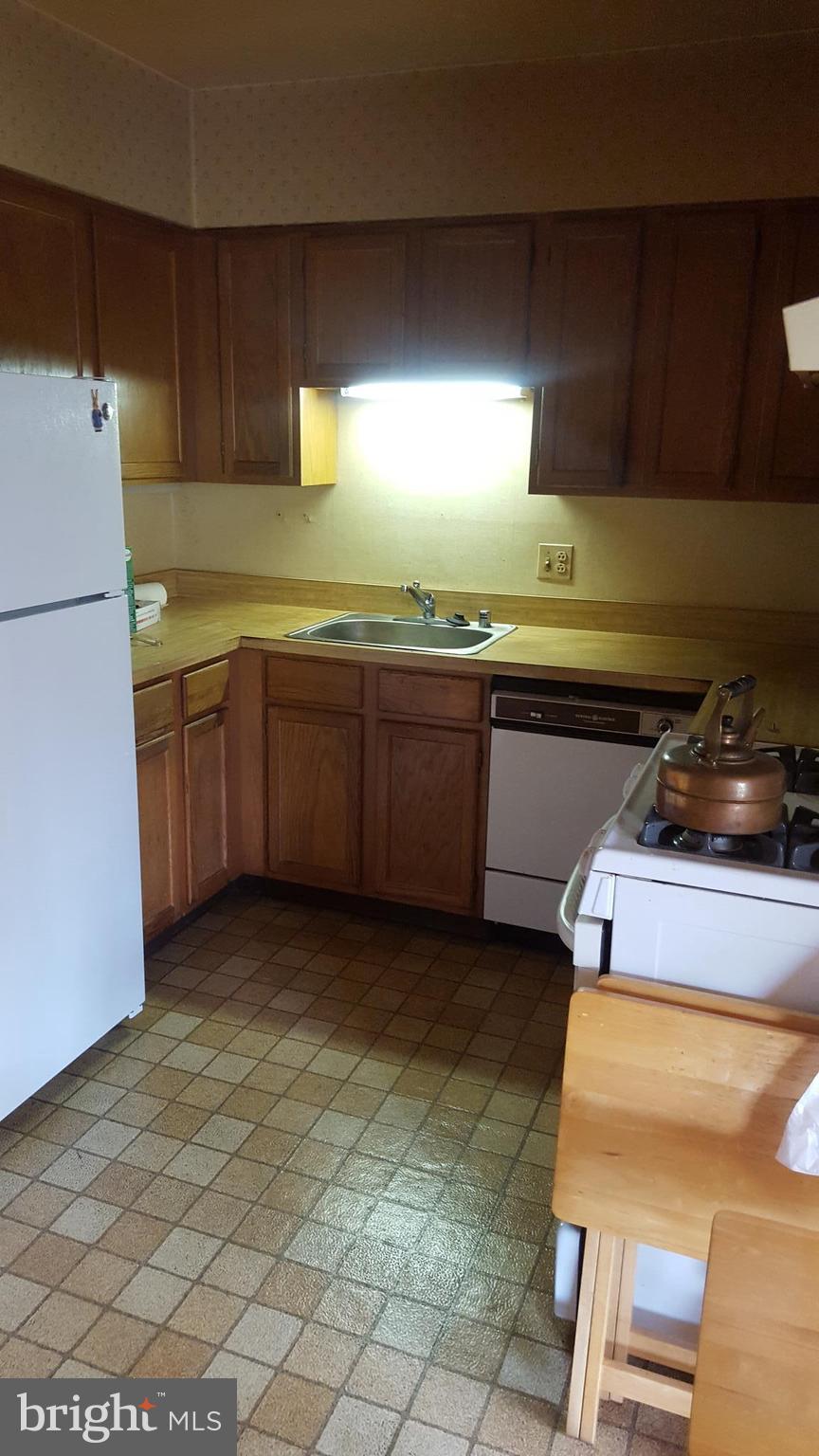 11 Hamill Road, Unit 11D Baltimore, MD 21210 - Photo 15 of 16 a kitchen with a refrigerator and cabinets