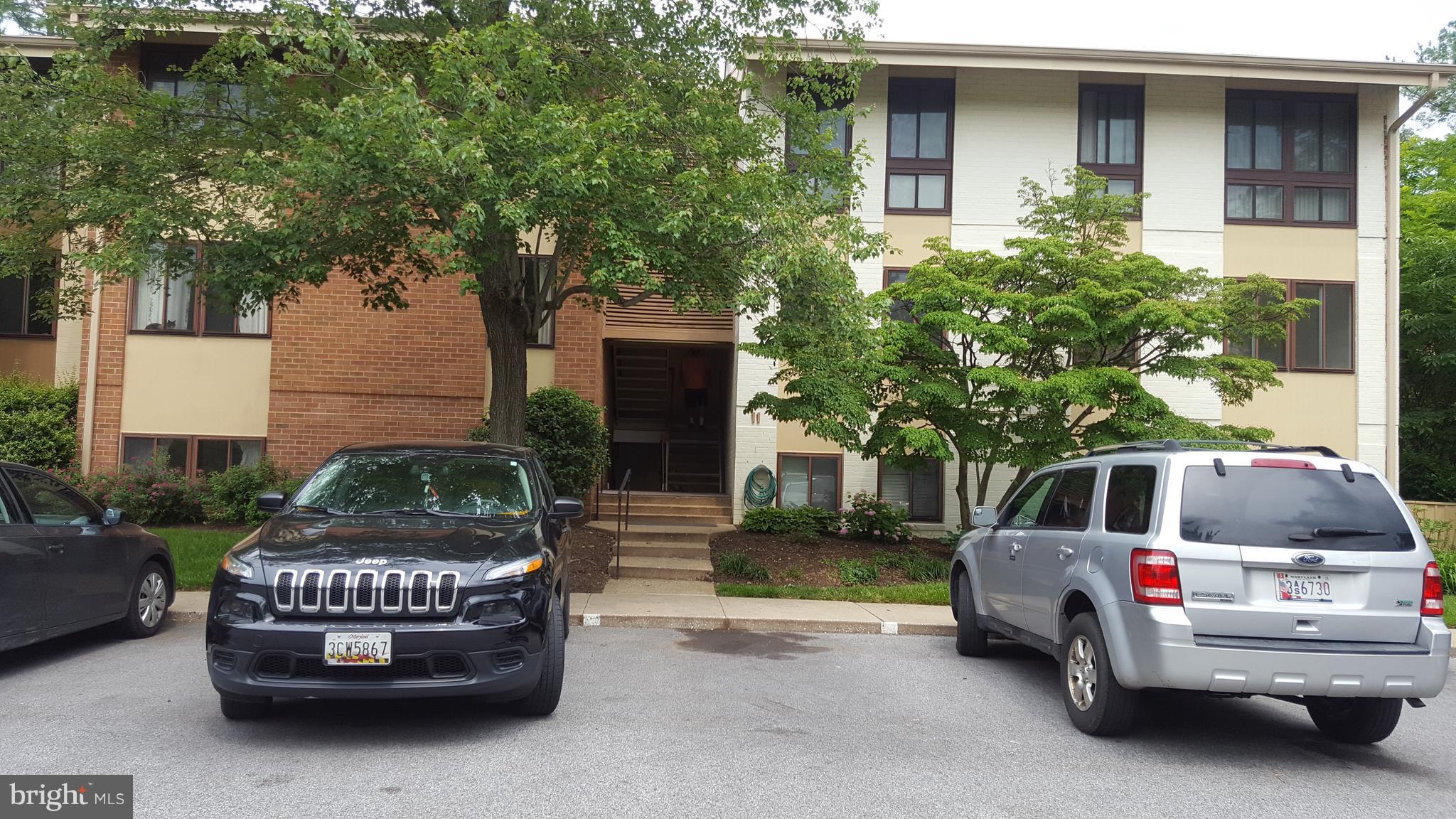 11 Hamill Road, Unit 11D Baltimore, MD 21210 - Photo 16 of 16 a car parked in front of white house