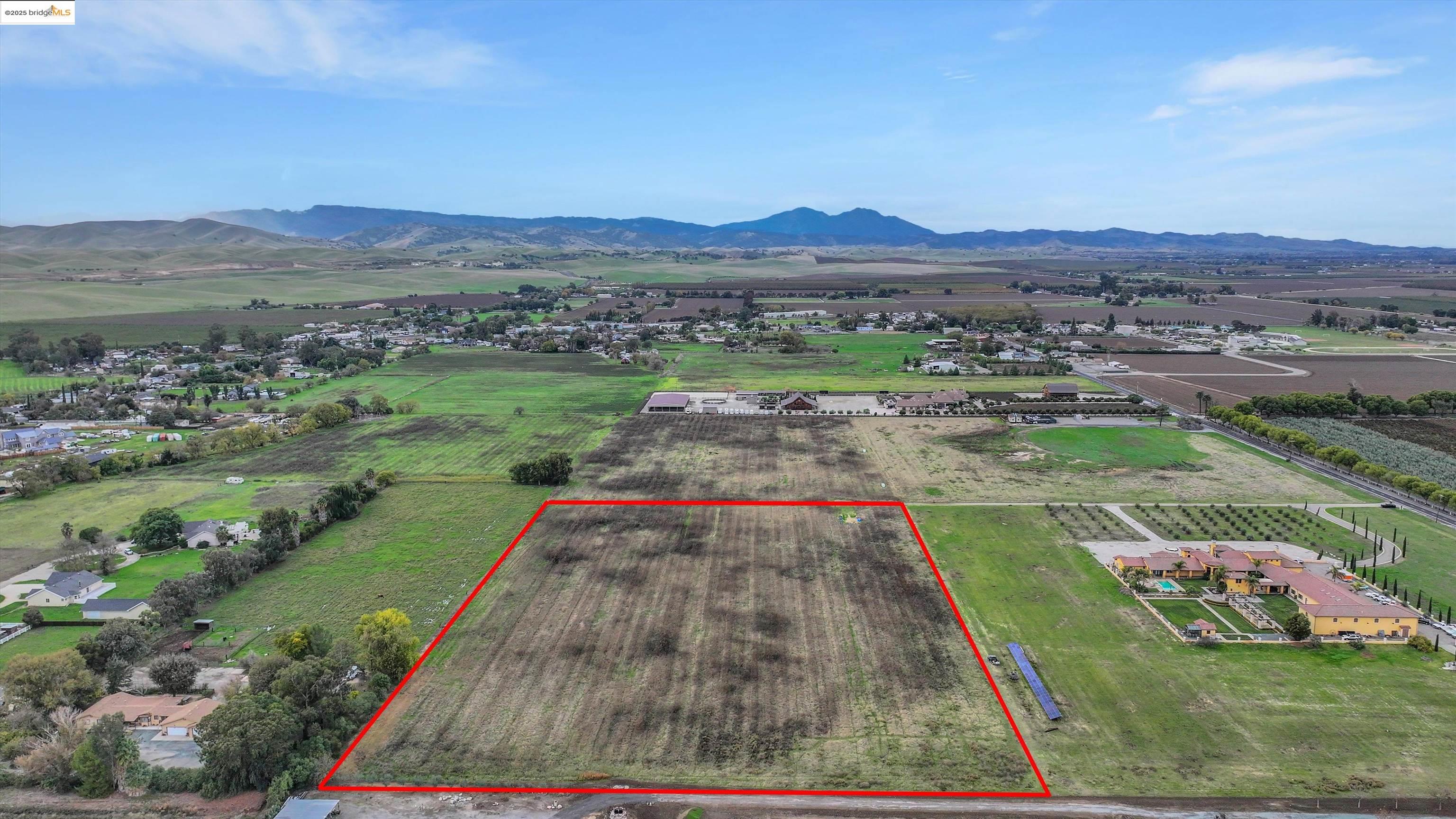 3590 Byer Road Byron, CA 94514 - Photo 8 of 12 Overview of rural landscape with property parcel outlined, a mountainous background, and extensive farmland