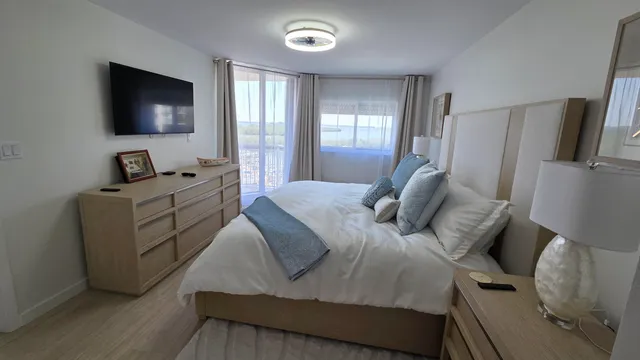 a bedroom with a bed and a flat screen tv