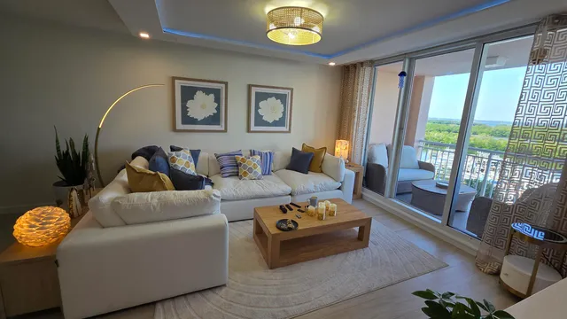 a living room with furniture and a floor to ceiling window